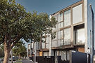 Residential townhouse development exterior with landscaped street
